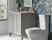 Decorative white toilet next to a grey bathroom sink cabinet unit.