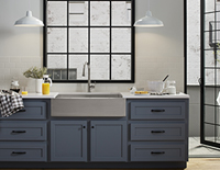 Built-in kitchen sink on top of a decorative kitchen cabinet & drawers.